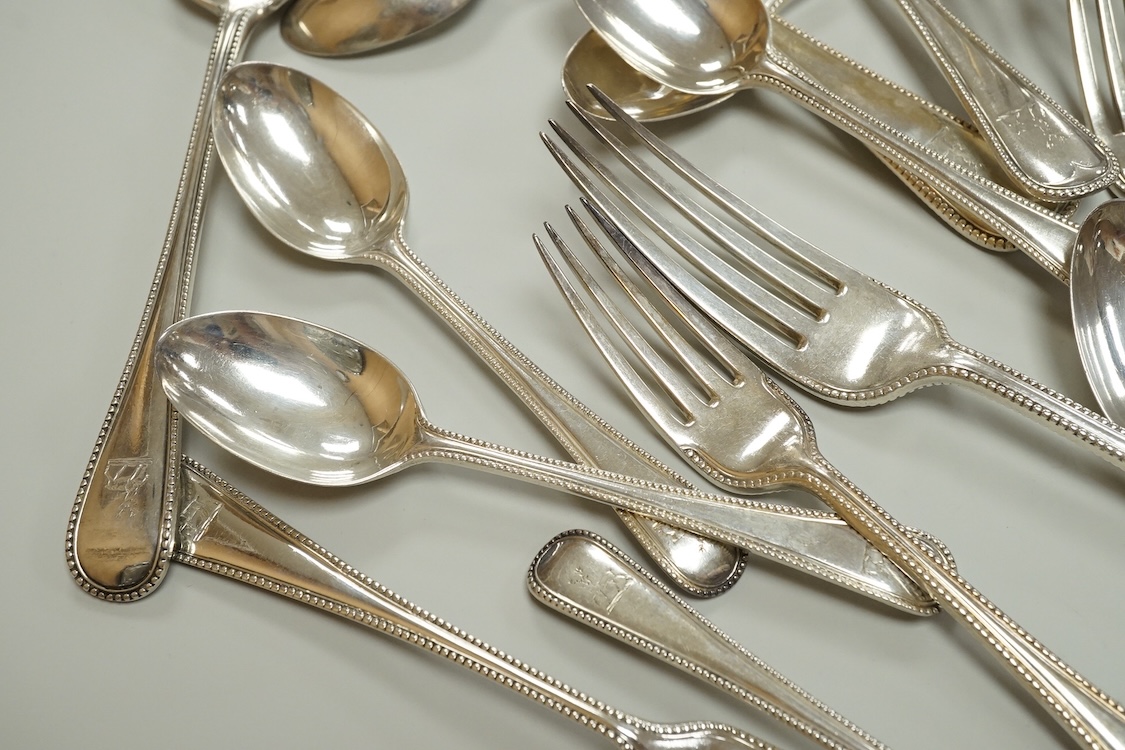 A harlequin part canteen of late Victorian and Edwardian silver beaded Old English pattern flatware, various dates and makers, comprising thirty items, 55.8oz.